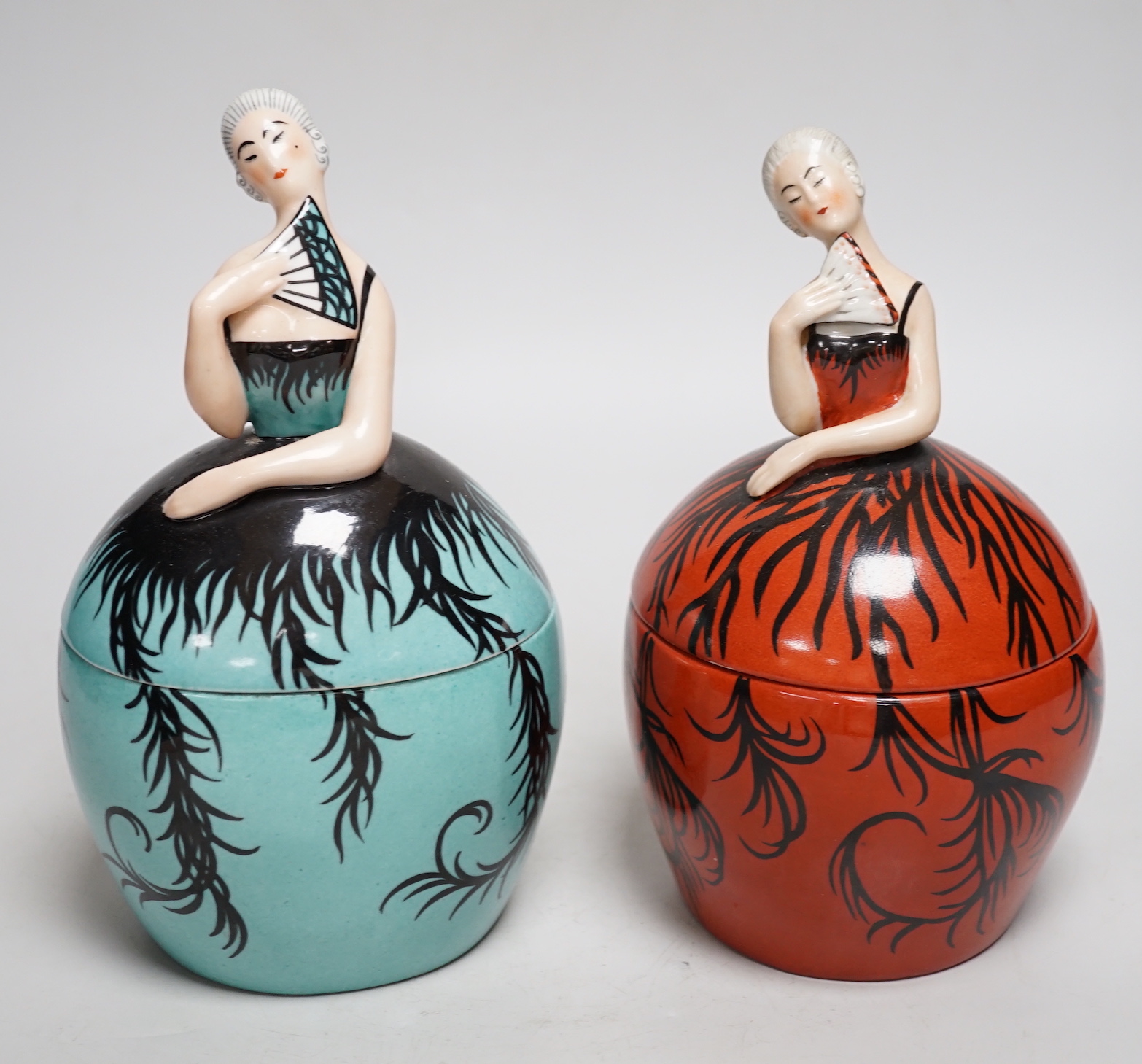 A 1930’s Robj figural ‘dancer’ powder bowl and cover and a similar powder bowl and cover, maker’s stamp on base, tallest 20cm